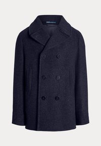 Mørk marineblå pea coat med brede kraver, dobbeltradet knaplukning foran og to lodrette sidelommer, lavet af tykt uldstof.