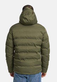 Olive green puffer jacket with a hood, featuring quilted sections, front pockets, and a smooth texture. Back view shows shape and fit.