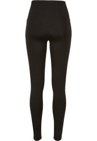 Leggings noirs à taille haute, fabriqués dans un tissu lisse et extensible. Pas de coutures ou de motifs visibles, conçus pour le confort et l'ajustement.
