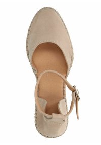 Beige suede espadrille with a closed toe and open sides, featuring a strap with a buckle. The sole is woven, offering a textured finish.