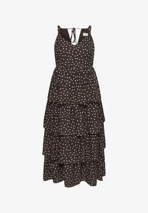 Rochie neagră fără mâneci, cu volane, buline albe, decolteu în V și închidere cu fundă la spate.