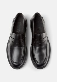 Pair of polished black leather loafers with a penny strap, rounded toe, and visible stitching on a white background.