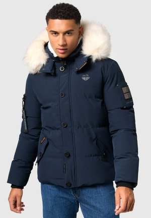 Navy blue puffer jacket with a faux fur hood, button closures, zip pockets, and logo accents. Features a quilted texture.