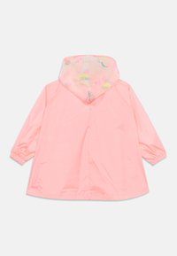 Ροζ αδιάβροχο με διαφανές κουκούλι που διαθέτει πολύχρωμα σχέδια. Μακριά μανίκια με ελαστικές μανσέτες, κατασκευασμένο από ελαφρύ, αδιάβροχο υλικό.