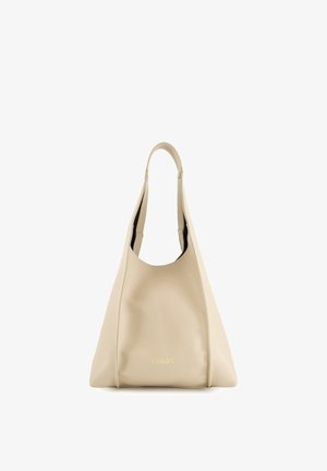 Beżowa skórzana torba tote o luźnym, zaokrąglonym kształcie. Posiada jeden uchwyt i subtelny detal z logo na dole. Gładka tekstura.