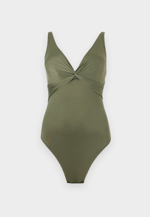 Oliviroheline üheosaline ujumistrikoo, mille V-kaelusel on keeratud sõlm ja laiad õlapaelad heledal taustal.