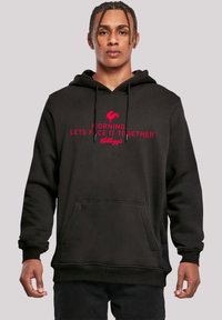 Schwarzer Hoodie mit Kängurutasche; mit rotem Text "MORGEN... LASST UNS DAS GEMEINSAM ANGEHEN" und einem Hahngrafik über "Kellogg's."