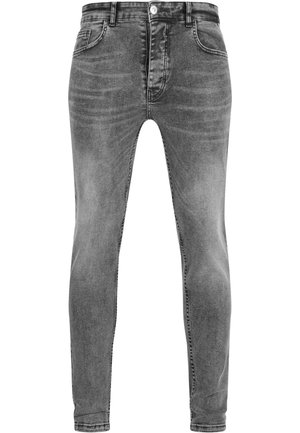 Jean en denim gris avec une coupe slim, design à cinq poches, finition délavée et coutures contrastées. Fermé avec un bouton en métal et une fermeture éclair.