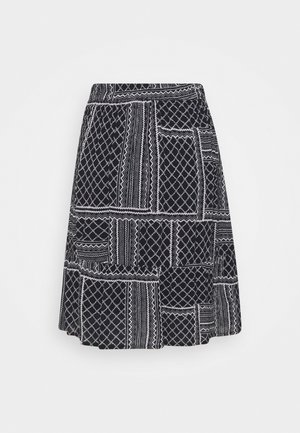 Black and white patterned skirt with a flared design. Features geometric and zigzag patterns, finishing above the knees with an elastic waistband.