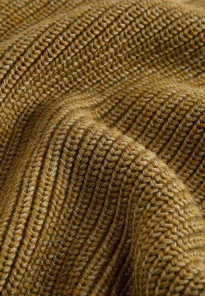 Geweven textiel in mosterdgeel, met een getextureerd ribbelpatroon van verschillende diktes, waardoor een warme en zachte uitstraling ontstaat.