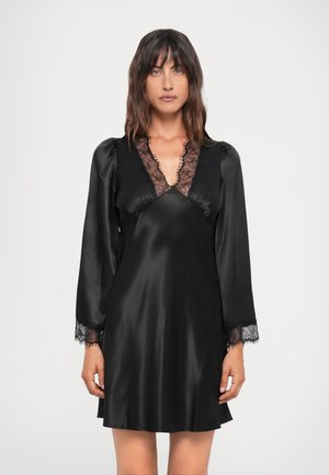 Black satin dress with long sleeves, lace accents at the neckline and cuffs, and a relaxed fit, showcasing a smooth texture and elegant design.