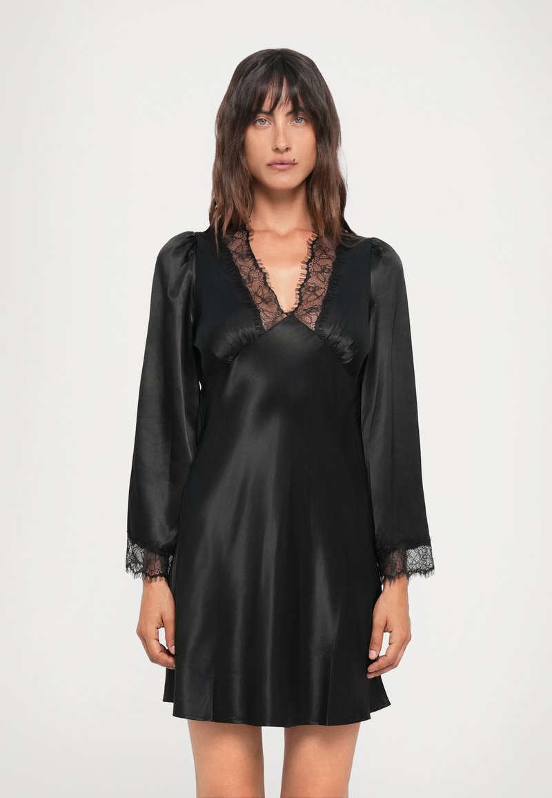 Black satin dress with long sleeves, lace accents at the neckline and cuffs, and a relaxed fit, showcasing a smooth texture and elegant design.