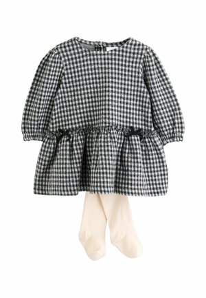 Musta-valkoinen ruudullinen pitkähihaisen vauvan mekko, jossa on kerrottu vyötärö ja pieniä nauhoja, yhdistettynä kermavärisiin legginsseihin.