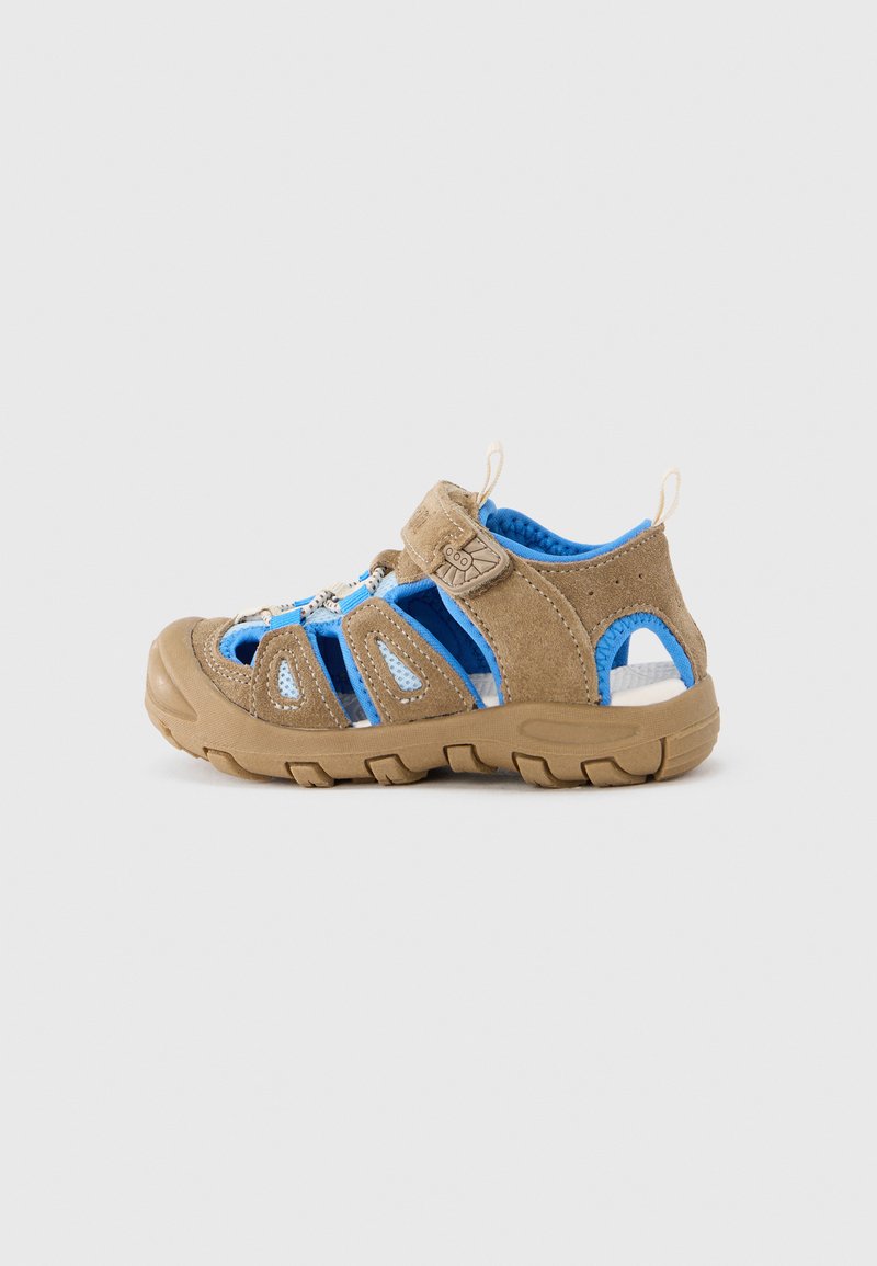 Sandalias infantiles marrones y azules con paneles de malla, correa de Velcro y suela de goma con agarres texturizados para tracción.