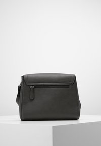 Borsa in pelle grigia con forma strutturata, chiusura a pattina e tasca frontale con zip. Presenta una tracolla lunga regolabile e una texture liscia.