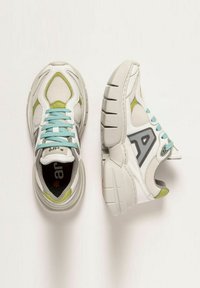 White athletic sneakers with mesh and leather, light green accents, grey logo, blue laces, and a thick textured sole with ridges.