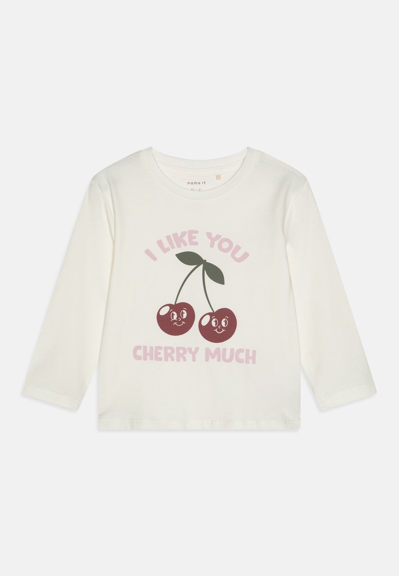 Long-sleeve cream t-shirt made of cotton. Features a graphic of two cherries with smiling faces and text reading "I LIKE YOU CHERRY MUCH."