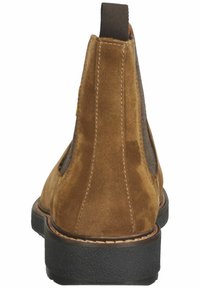 Braune Wildleder-Stiefeletten mit elastischen Seitenpaneelen, gesteppten Details und Gummisohle. Leicht strukturierte Oberfläche mit einer Zuglasche an der Ferse.