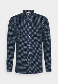 Camicia blu navy con bottoni e motivo di piccoli cerchi azzurri. Presenta un colletto classico e maniche lunghe con polsini abbottonati.