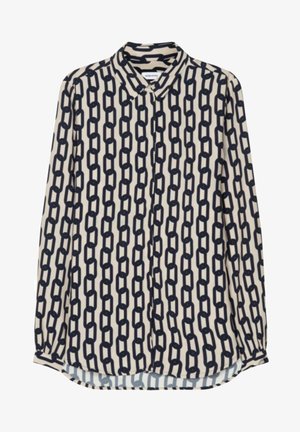 Blouse crème à manches longues avec motif de maillons noirs, fermeture à boutons sur le devant et col pointu.