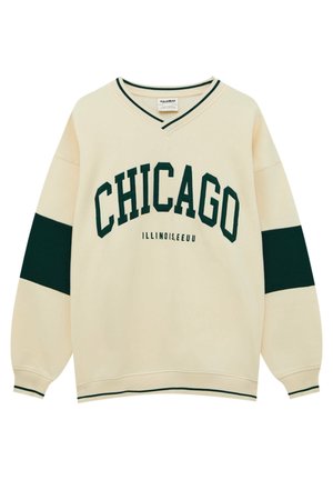 Bluza w kolorze kremowym z zielonym napisem "CHICAGO", mniejszym napisem "ILLINOIS, EEUU", zielonymi paskami na rękawach oraz zielonym wykończeniem dekoltu w serek i mankietów.
