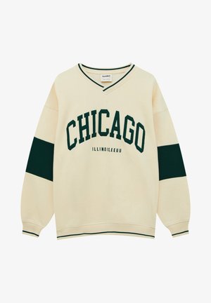 Cremefarbener Pullover mit grünem "CHICAGO" Schriftzug, kleinerem "ILLINOIS, EEUU" Schriftzug, grünen Streifen an den Ärmeln und grün eingefasstem V-Ausschnitt und Bündchen.