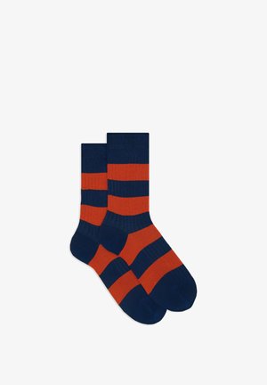 Ribbed socks featuring alternating navy blue and orange stripes. Made from stretchable fabric for comfort.