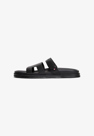Black men's sandals with two wide straps and cut-out details. Made of smooth material, featuring a flat sole and a textured strap accent.