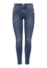 Jean skinny en denim bleu foncé avec une texture délavée, présentant des détails usés et un design classique à cinq poches avec des éléments métalliques.