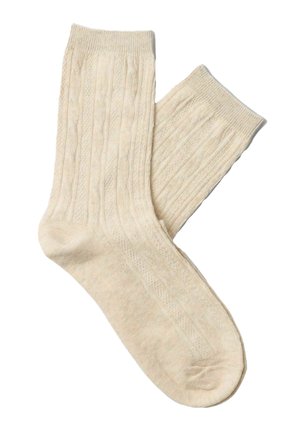 Beżowe prążkowane skarpetki dziane z fakturowanym wzorem i elastycznymi mankietami. Miękki, lekki materiał zaprojektowany dla komfortu i ciepła.