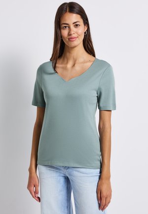 T-shirt à col en V à manches courtes en doux tissu vert menthe, présentant une coupe décontractée et une texture lisse. Design simple sans motifs ni embellissements.
