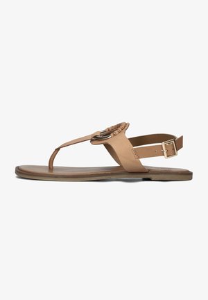 Tan leather sandal featuring a toe post design, a braided strap, and a gold-tone buckle. Flat sole with a smooth texture and minimalistic style.