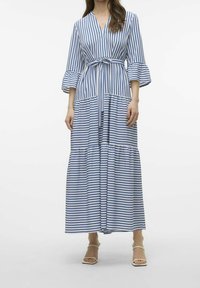 Vestido maxi a rayas en azul y blanco con escote en V, cintura ceñida con cinturón, mangas acampanadas y dobladillo de capas, hecho de tela ligera.