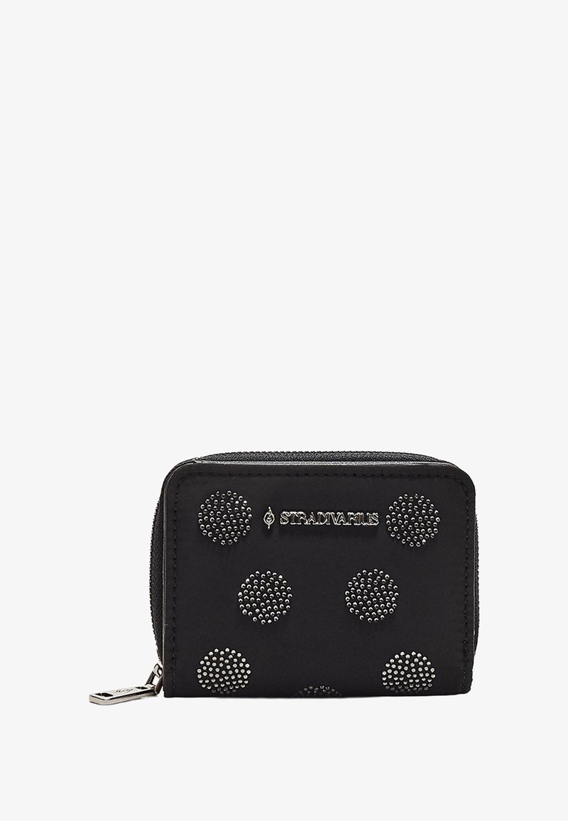 Portafoglio nero con cerniera, caratterizzato da design circolari a borchie. Presenta il logo, una texture liscia e una forma rettangolare compatta. Inclusa una linguetta metallica per la cerniera.