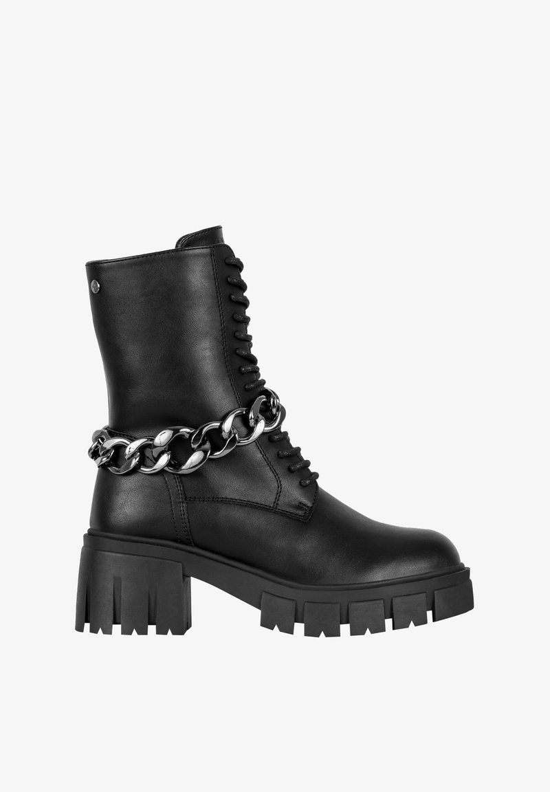 Black leather ankle boot with a chunky platform sole, lace-up front, and a metallic chain accent around the ankle. Textured finish.