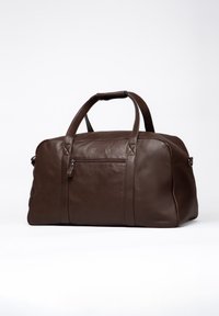 Brown leather duffel bag with top handles, a zippered front pocket, and subtle stitching details. Smooth texture, spacious design for travel.
