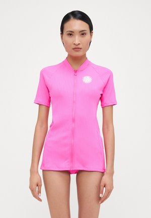 Short-sleeve, bright pink surf top, featuring a zip front, ribbed texture, and a round logo on the chest. Lightweight and fitted design.