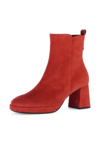 Red suede ankle boot with a rounded toe and a block heel. Features a smooth texture and a pull tab at the back for easy wear.