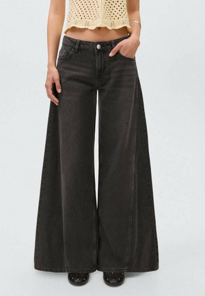 Wide-leg black denim jeans with a high waist, featuring a front button closure and pockets. The fabric has a smooth, textured appearance.