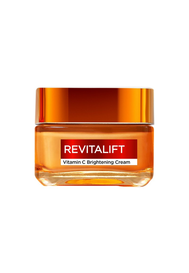 Crema illuminante Revitalift al Vitamina C in un barattolo di vetro trasparente con coperchio arancione sfumato, che mostra una superficie liscia e un design etichetta audace.