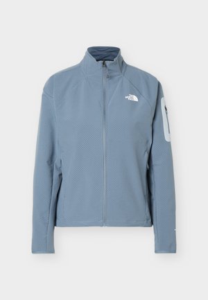 Light blue zip-up North Face jacket with high collar and zippered pocket on the left sleeve, displayed against a white background.