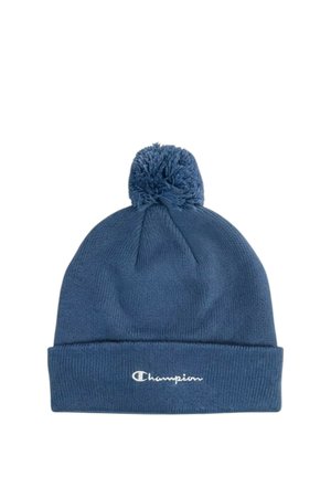 Cappellino di lana blu con pompon in cima e risvolto, con il logo Champion bianco ricamato sul davanti.