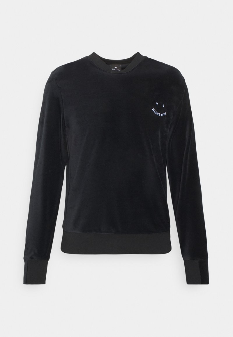 Sweat-shirt en velours noir avec manches longues, encolure ronde, et petit graphique de visage souriant blanc sur la poitrine. Poignets et ourlet côtelés.