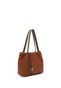 Sac à main en cuir marron avec double bandoulière, pompon décoratif et breloque argentée, posé sur un fond blanc.