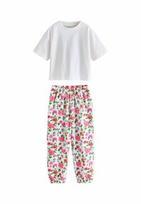 White short-sleeve t-shirt paired with elastic-waist floral print pants featuring pink and red flowers on a white background.