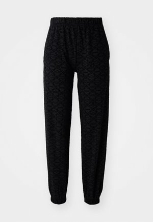 Black jogger pants with an elastic waistband and cuffs, featuring a subtle geometric pattern and soft texture.