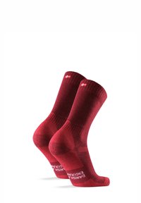Punaiset urheil socksit, joissa on uritettu muotoilu, keskipituus, tekstuurinen kangas ja logo-yksityiskohta pohjassa. Kuusikulmainen kuvio yläosassa.