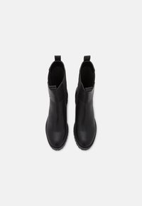 Bottines en cuir noir avec une texture lisse, des languettes pour un enfilage facile, et des semelles robustes pour une adhérence, présentant un design élégant.
