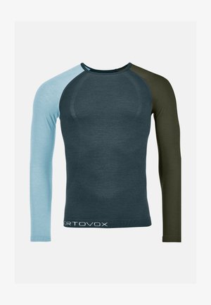 Long-sleeve shirt in dark blue, light blue, and olive green. Features a fitted design, contrasting sleeves, and a white logo at the hem.