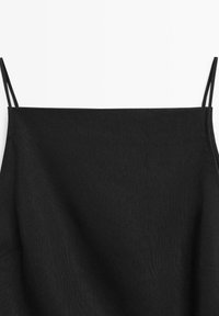 Black spaghetti strap dress with square neckline made of textured fabric.